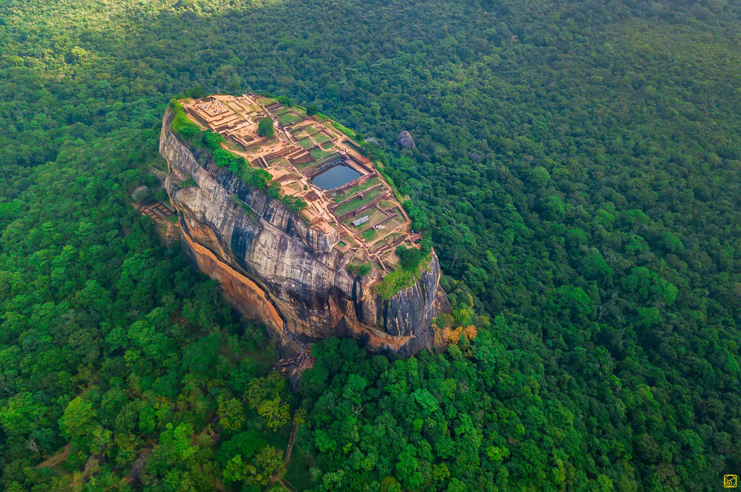 Aerial view of Sigiriya Rock Fortress rising above the jungle canopy